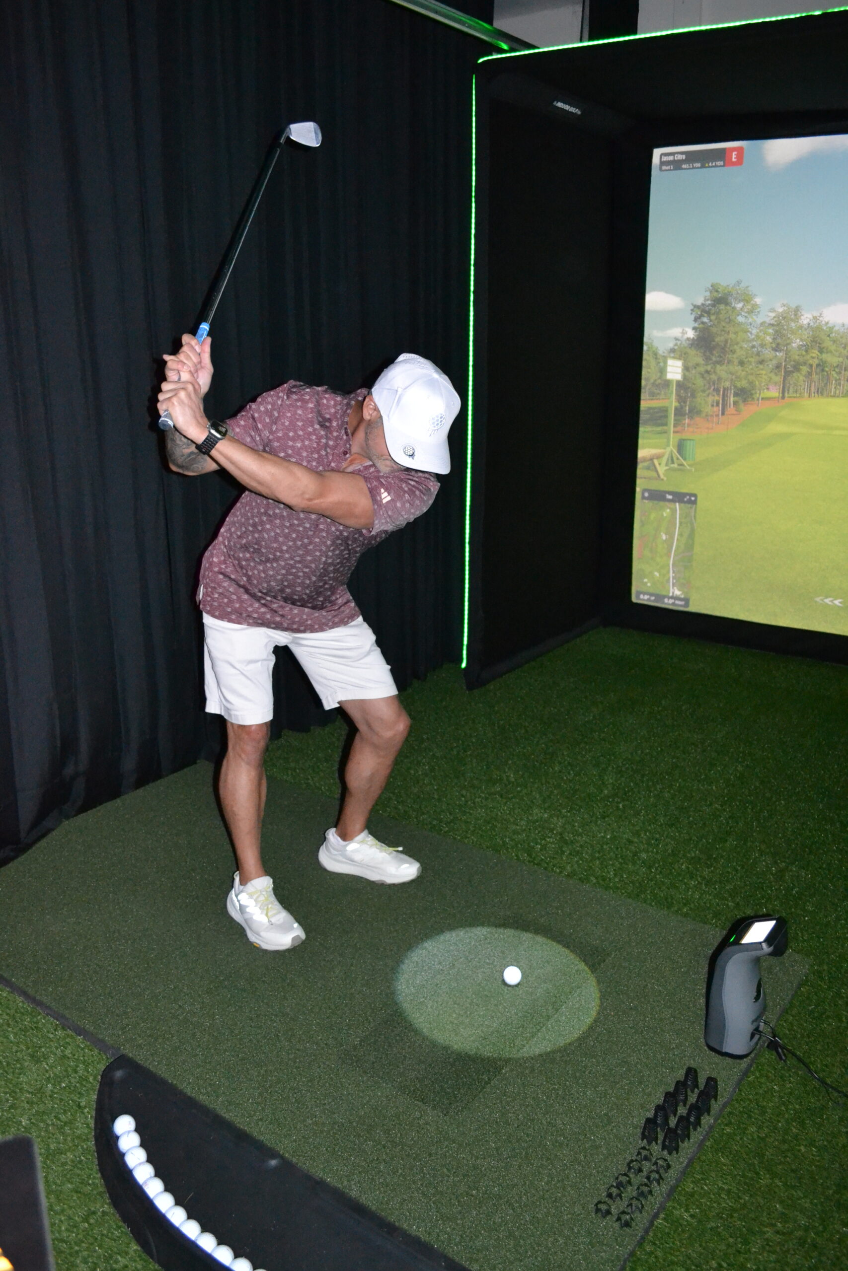 Family enjoying a golf simulator game night in South Florida home.